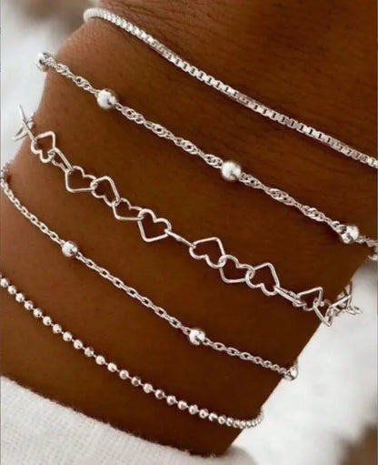 A golden six-piece set Chic Multi-Layered Alloy Bracelet Set - Fashionable Stackable Jewelry Femina Worldwide